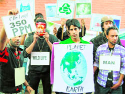 Youths take part in an environment awareness rally organised by the CRPF on the occasion of World Earth Day in Srinagar on Friday