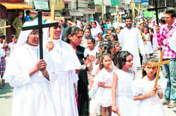 Devotees participate in a procession on the occasion of Good Friday in Jammu
