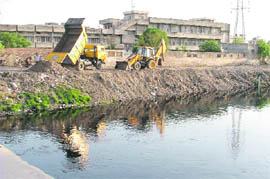MC staff clean up Budha Nullah ahead of Union Minister for Environment Jairam Rameshs visit to Ludhiana.