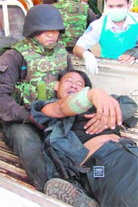 Thai soldiers evacuate a soldier after he was shot in an exchange of gunfire with Cambodian troops near the Thai-Cambodian border on Friday