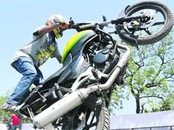 A biker performs stunts during the Auto Mall 2011 in Ludhiana