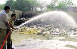 Fire fighters douse the fire that broke out at a book market in Ludhiana on Saturday