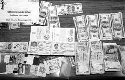 Currency and fake visiting cards recovered from the accused in Rajpura on Sunday