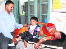 A woman with members of her family under treatment at Doon Hospital on Sunday