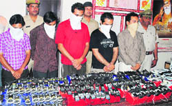 Members of the cricket betting gang along with the seized mobile and landline phones in Karnal on Sunday