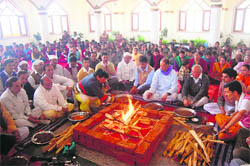 Devotees pay tributes to Sai Baba in Pujarli, Shimla, on Sunday.