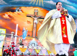 Father of Sarabha Nagar Church offers prayers on the occasion of Easter in Ludhiana on Sunday