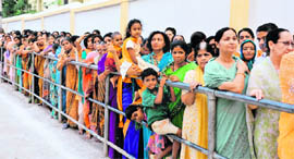 Devotees wait for their turn to pay their last respects to Sathya Sai Baba