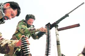 A Libyan rebel prepares a heavy machinegun before heading to the battle front of Ajdabiyah on Sunday