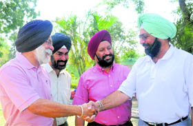 Outgoing president BS Gill greets Malvinder Singh (right) on his victory in the Chandigarh Golf Clubs presidential race in Chandigarh on Monday.