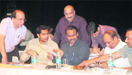 SDM (South) Parshuram Kavle, UT ADC ML Sharma and (standing) Assistant Excise and Tax Commissioner Naresh Dubey during a draw of lots for liquor vends in Chandigarh on Monday. 