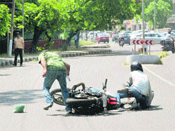 A biker and a pedestrian after their collision on a road at Sector 18, Chandigarh, on Monday. 