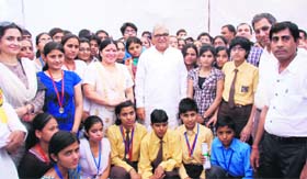 Chief Minister Bhupinder Singh Hooda poses with meritorious students who were honoured during a function in Bhiwani