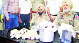 District police chief Preetpaul Singh Virk with the contraband in Tarn Taran on Monday.