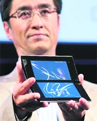 Kunimasa Suzuki, Deputy President of Sony's consumer products and services group, holds Sony's first tablet PC S1 at its unveiling ceremony in Tokyo, on Tuesday