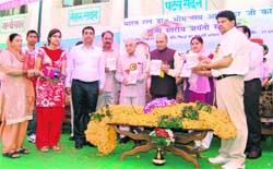 Chief Minister PK Dhumal releases a book on Dr BR Ambedkar in Hamirpur.