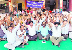 Members of the Employees Joint Action Committee stage a protest in Jammu on Tuesday