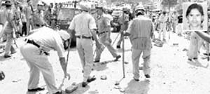 A police team removes bricks from a road after the demonstration by victim Vijay Kumars (inset) kin and neighbours in Ambala Cantonment