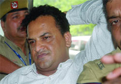Former Indian cricketer Jacob Martin being produced before the media at PHQ, IGI Airport, in New Delhi on Wednesday. 