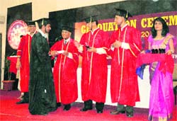 A student receives his degree certificate at the graduation ceremony of ICFAI University in Dehradun