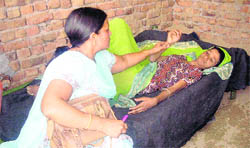 Radha lies on a bed at her brothers house in Jakhal (Fatehabad) before being shifted to a pingalwara on Wednesday