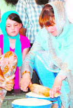 South Australias Minister of Multicultural Affairs Grace Portolesi makes a chapati at the Golden Temple on Wednesday