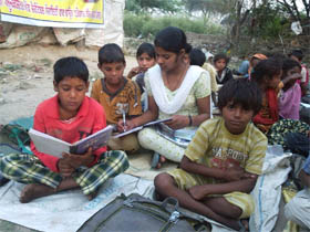 Kids from slum areas studying after returning from work at an evening school run by the NGO in Barnala.