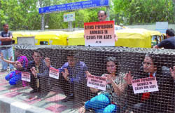 PETA activists demonstrate against AIIMS for imprisoning animals in New Delhi on Thursday