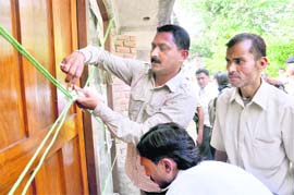Employees of the MDDA seal a building in the possession of Sachin Upadhyaya, brother of a Congress legislator, in Dehradun