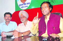 Vinod Bharathwal (right), president of the Uttarakhand unit of the Samajwadi Party, addresses a press conference in Dehradun