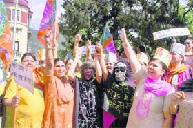 Activists of the BJP Mahila Morcha raise slogans in Shimla on Thursday