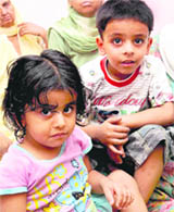5-year-old Pratham and two-and-a half-year-old Mannat wait for their mother in their Sector 56 house on Friday.