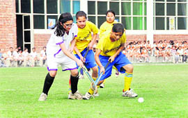 Players in action in a match in the Dehradun District Council School Association Inter-school Girls Hockey Tournament in Dehradun on Friday.