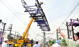 Another steel structure of Lakkar Bridge being pulled down with the help of a crane in Ludhiana on Friday.