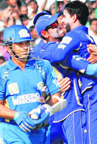 Mumbai Indians Sachin Tendulkar walks off after being dismissed as Rajasthan Royals players celebrate in Jaipur on Friday. Rajasthan Royals won the match by seven wickets