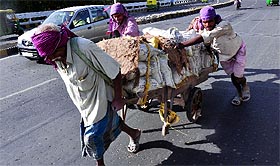 There is no relief from the burden of everyday existence for these labourers on the eve of International Labour Day, in New Delhi on Saturday.