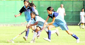 A match under way between Guru Nanak Academy and Welham Girls School in the Dehradun District Council Schools Association Inter-school Girls Hockey Tournament in Dehradun on Saturday.