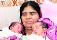 Jagdish with her twins in Karnal on Saturday.