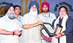Chief Minister Parkash Singh Badal presents an award at the All-India Punjabi Conference at Punjabi University in Patiala on Saturday