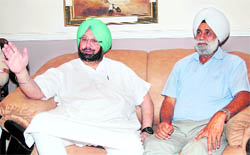 Capt Amarinder Singh with the father of Gurkirat Singh Sekhon in Jalandhar on Saturday
