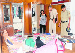 Police officials inspect the house at Sector 21, in Chandigarh where a theft was reported, on Sunday.