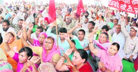 Members of various trade unions hold a rally to observe May Day at the railway station in Amritsar on Sunday.