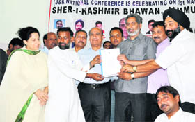 National Conference workers give a memorandum to Higher Education Minister Abdul Gani Malik at the party office on Sunday.