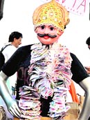 Residents protest with an effigy of corruption in Mumbai on Sunday.