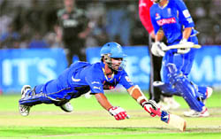 Rajasthan Royals Ajinkya Rahane dives to avoid being run out against Pune Warriors during their match in Jaipur on Sunday. Rajasthan Royals won by six wickets
