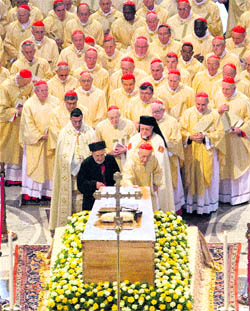 Cardinals touch the casket of late Pope John Paul II in St Peters Basilica in the Vatican following his beatification on Sunday.