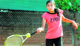 Neamat Aulakh of Sacred Heart School plays a forehand return during the Total Tennis Tournament at Ajit Karam Singh International Public School in Sector 45, Chandigarh, on Monday.