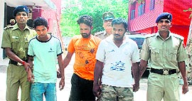 The accused in police custody in Chandigarh on Manday; and (below) vehicles recovered from the gang.