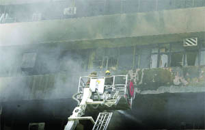 Delhi fire personnel try to douse flames at the sixth floor of the Lok Nayak Bhawan in New Delhi on Monday.