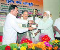 Former Uttarakhand Chief Minister BC Khanduri is honoured at a function organised by the Uttarakhand Public Forum by environmentalist Sunderlal Bahuguna and Leader of the Opposition Harak Singh Rawat in Dehradun on Monday